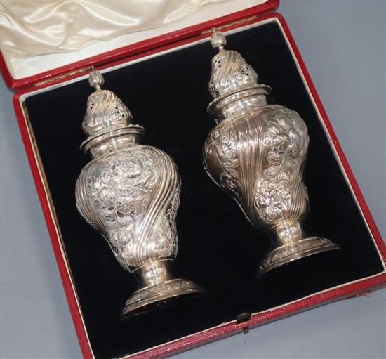 A cased pair of late Victorian silver sugar casters, Daniel & John Welby, London, 1897, 14.5 oz.